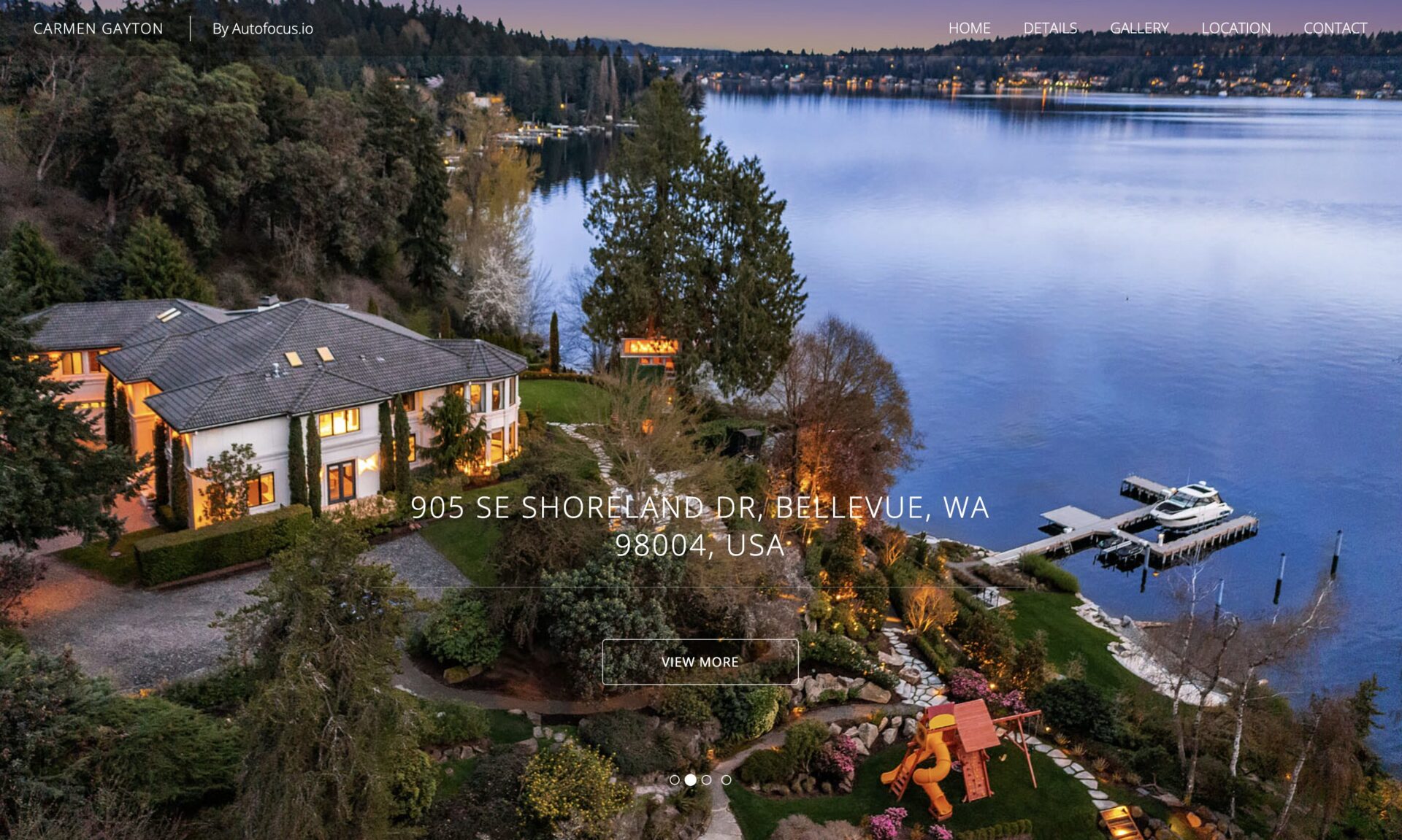 An aerial view of a luxurious property at 905 SE Shoreland Dr, Bellevue, WA, 98004. The estate is located by a lake, surrounded by lush greenery and gardens. Features include a large house, manicured lawn, and a private dock extending into the water—ideal for top real estate property websites.