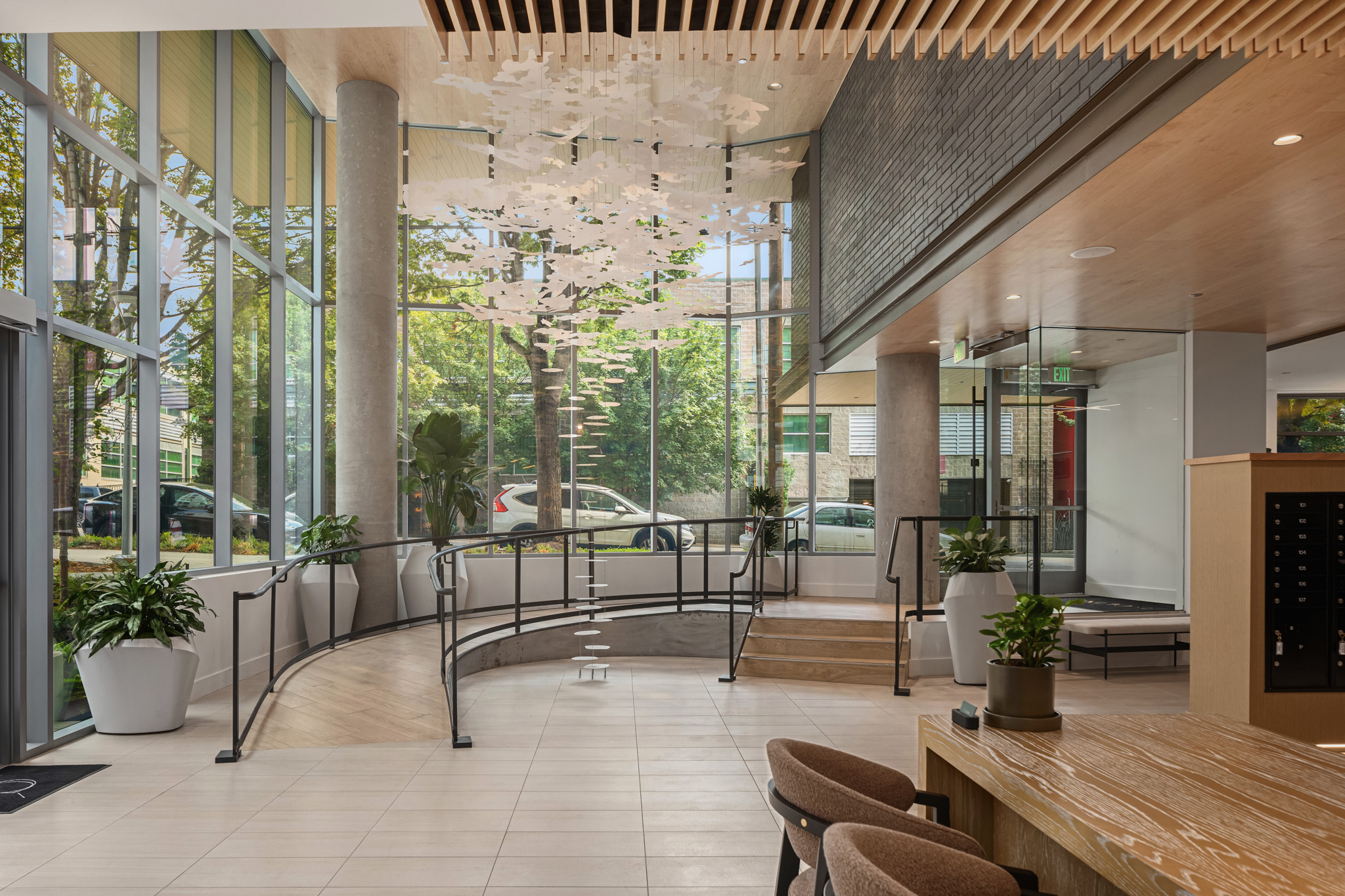Modern lobby space featuring large windows, elegant wood accents, and contemporary decor, located in the Pacific Northwest.