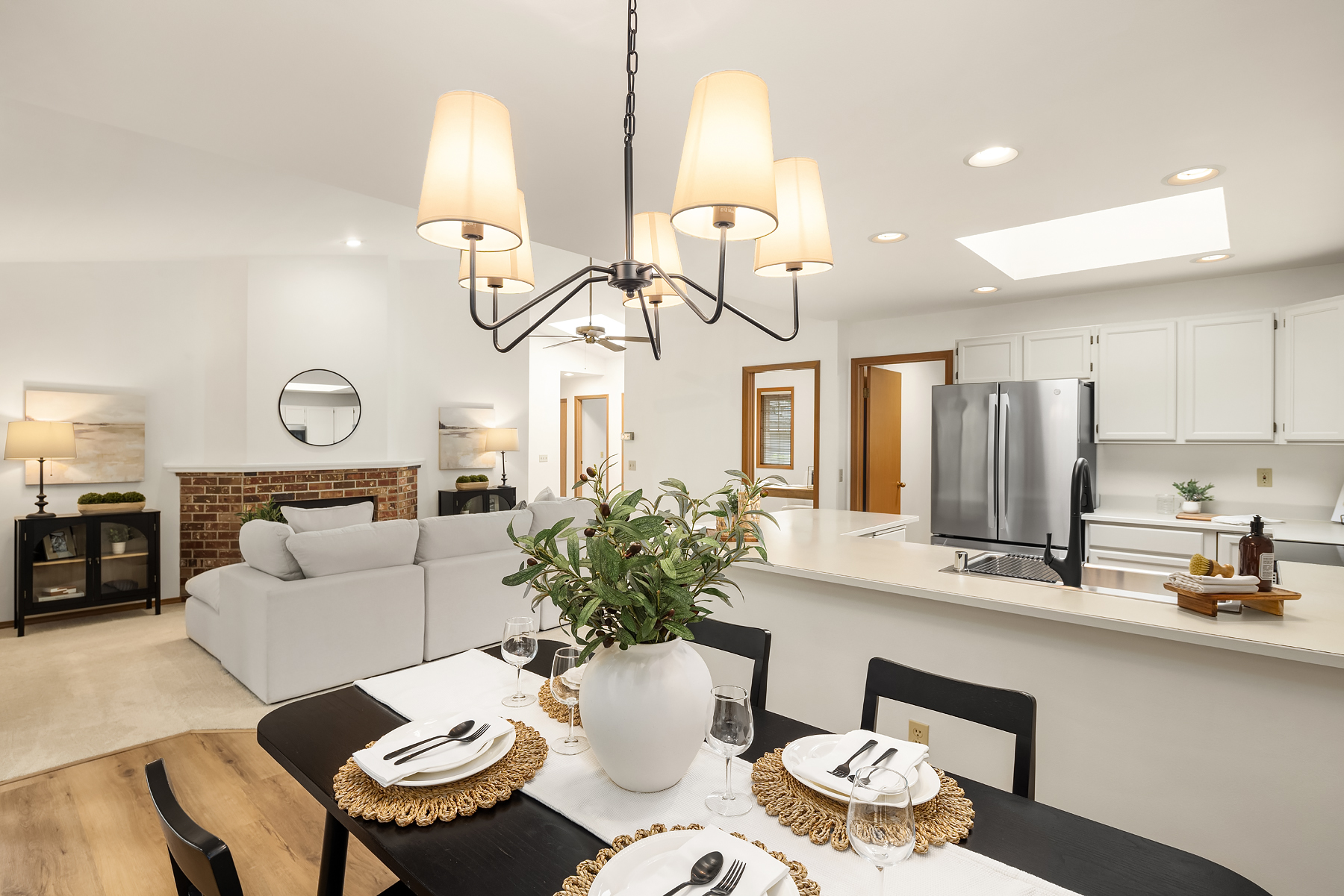 Modern open-concept dining and kitchen area featuring elegant decor, natural light, and a cozy ambiance, located in the Pacific Northwest.