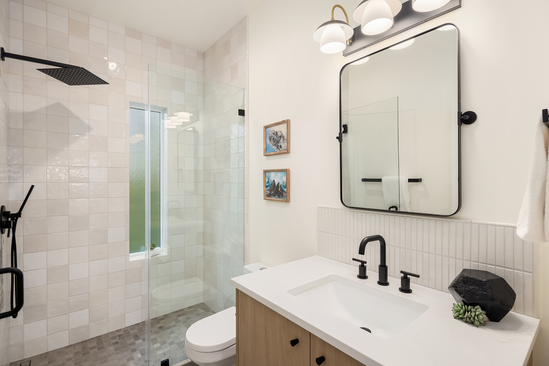 Modern bathroom featuring a walk-in shower, stylish fixtures, and a clean, minimalist design. Located in the Pacific Northwest, this space exudes elegance and tranquility.