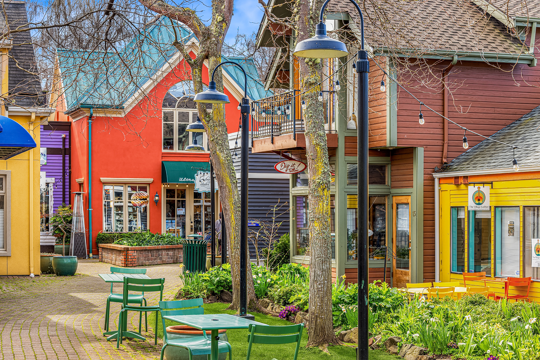 Colorful storefronts and outdoor seating in a charming village setting, showcasing a vibrant, modern atmosphere in the Pacific Northwest.